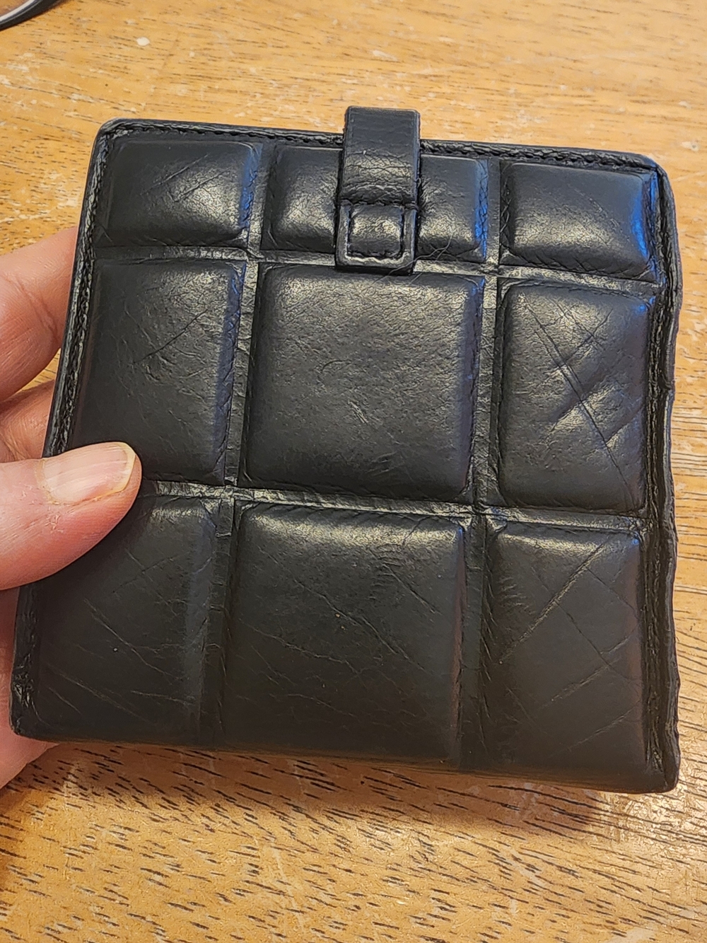 black, quilted leather Bottega Veneta compact bifold wallet.